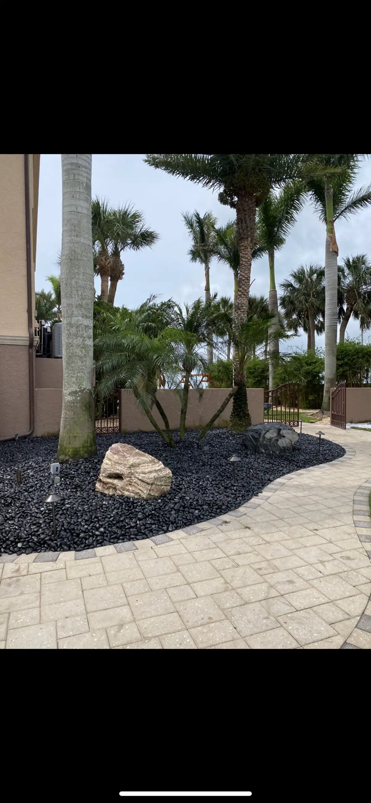 Backyard hardscaping with pavers and retaining wall in Pinellas County